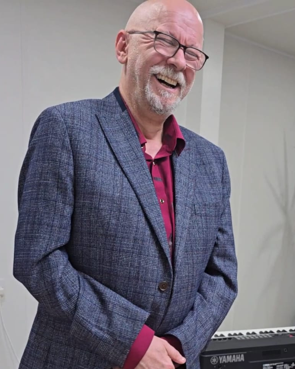 Darren Jewell smiling during a speaking appearance